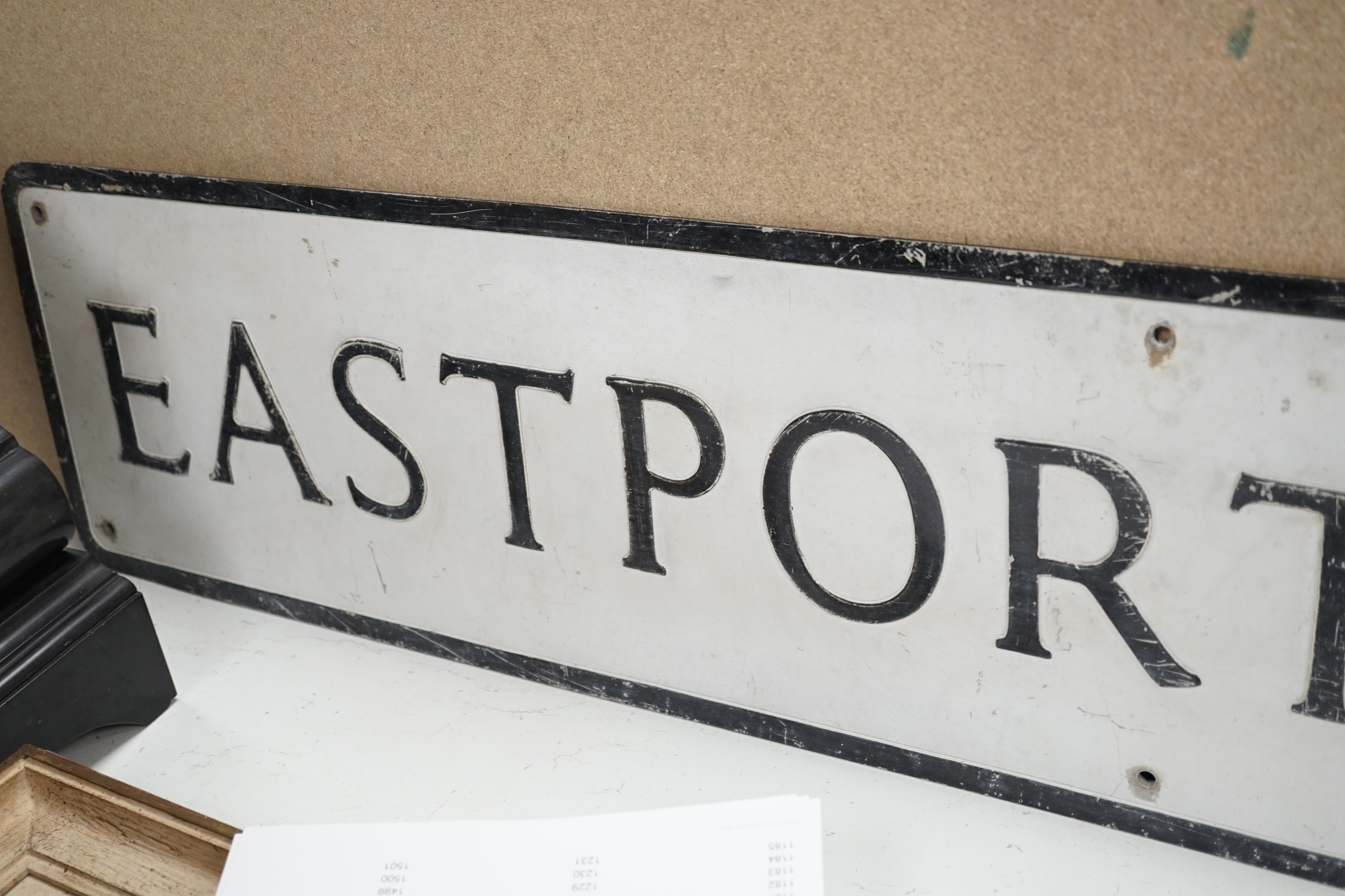 An enamel advertising sign: A.V. Welch & Co, and an Eastport Lane aluminium street sign, latter 105cm long